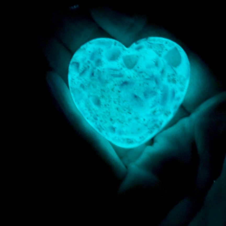 Aqua glow worry stone glowing in the dark